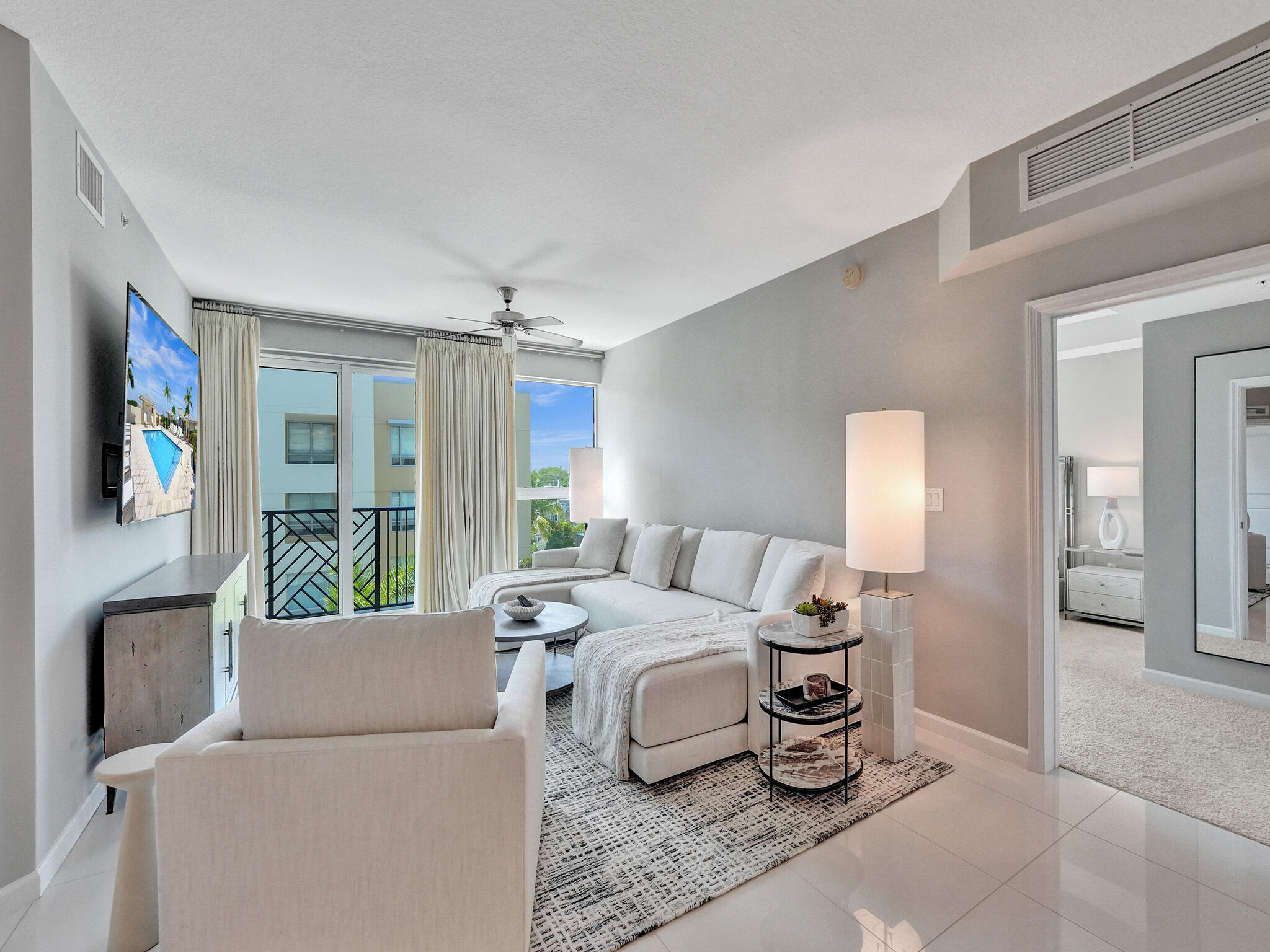 225 Northeast 1st Street, Unit 412 Delray Beach, FL 33444 - Photo 12 of 49 a bedroom with furniture and a chandelier