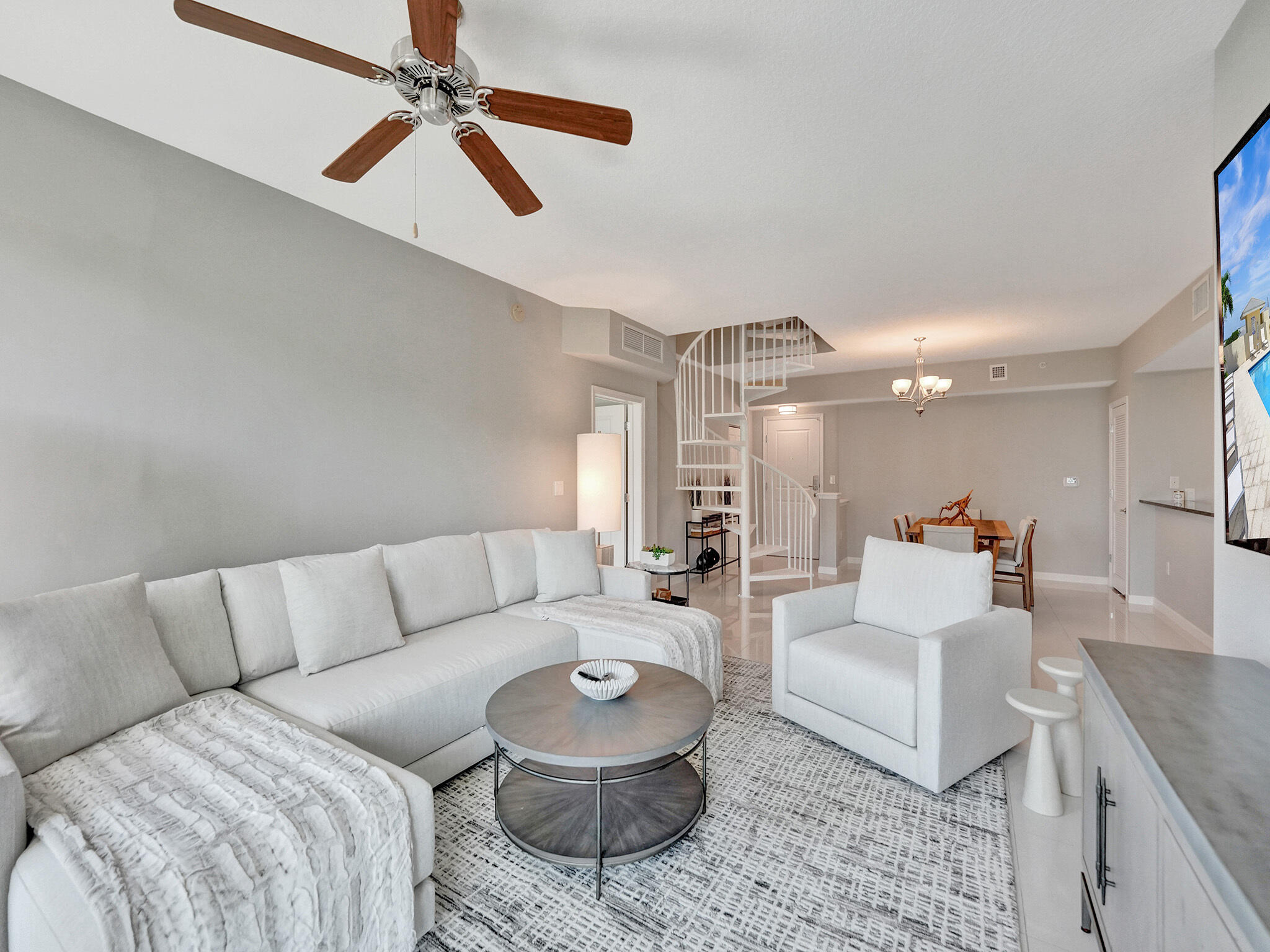 225 Northeast 1st Street, Unit 412 Delray Beach, FL 33444 - Photo 13 of 49 a living room with furniture and a chandelier