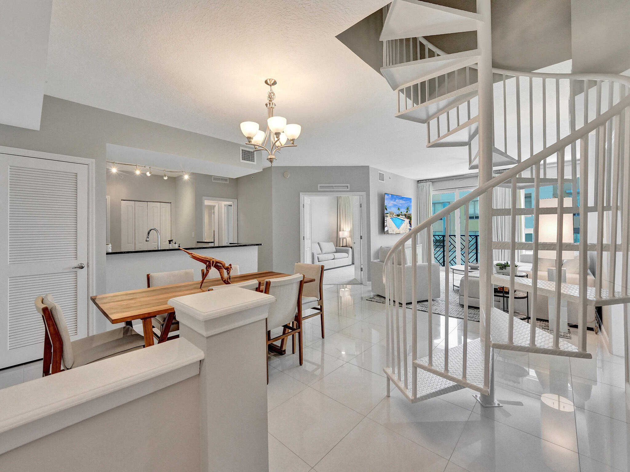 225 Northeast 1st Street, Unit 412 Delray Beach, FL 33444 - Photo 2 of 49 a living room with lots of furniture and a chandelier