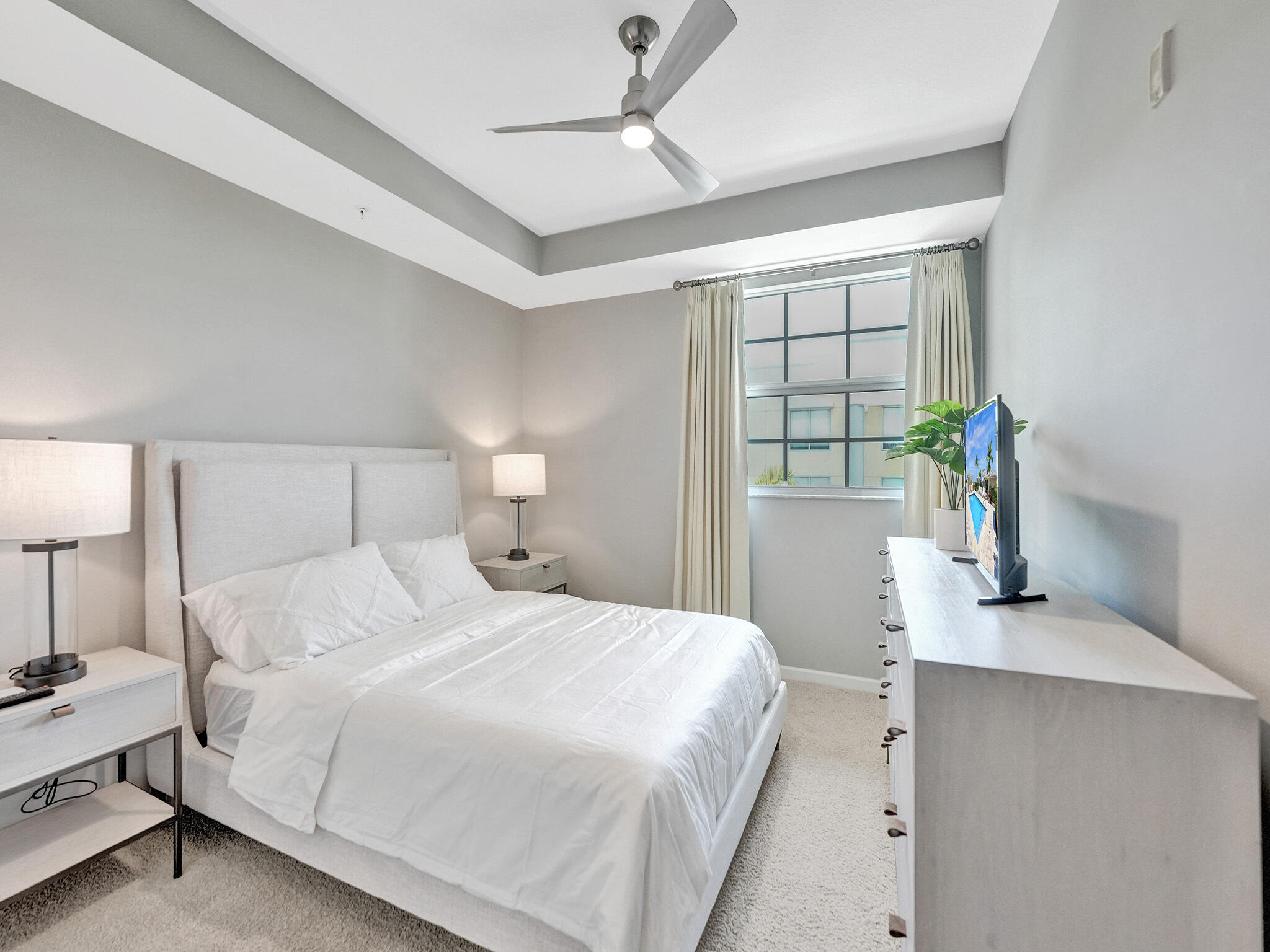 225 Northeast 1st Street, Unit 412 Delray Beach, FL 33444 - Photo 20 of 49 a bedroom with a large bed and a window