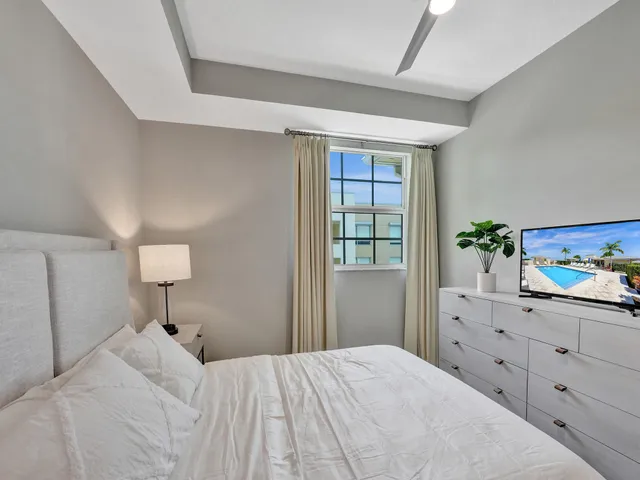 a bedroom with a large bed and a window