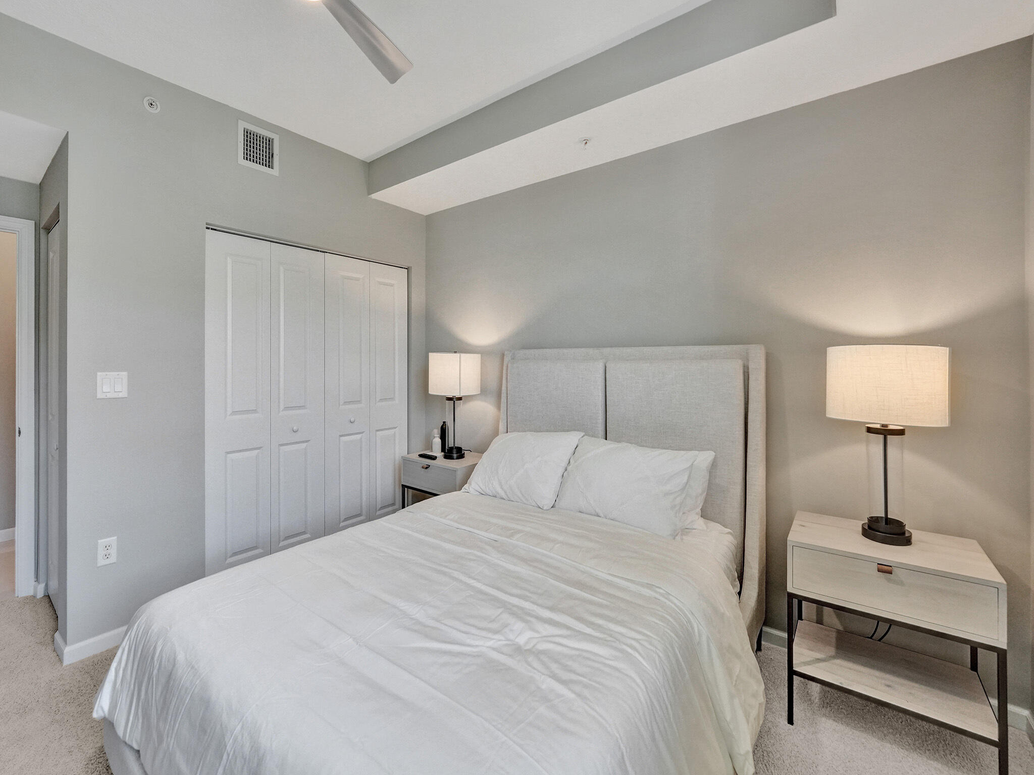 225 Northeast 1st Street, Unit 412 Delray Beach, FL 33444 - Photo 22 of 49 a bedroom with a bed and a lamp