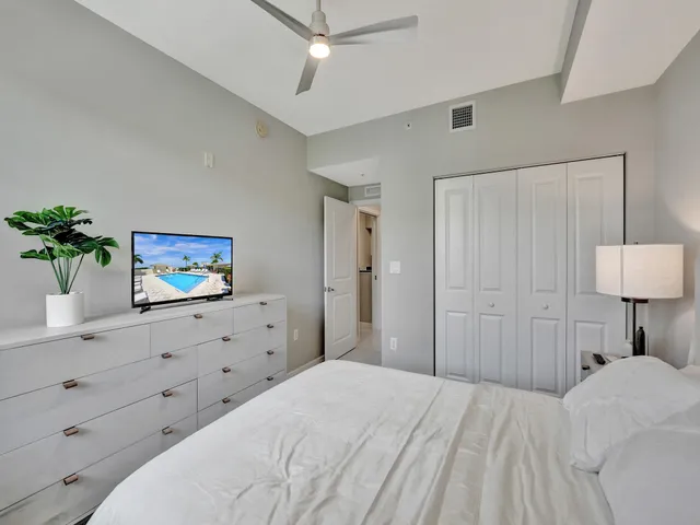 a bedroom with a bed and a lamp