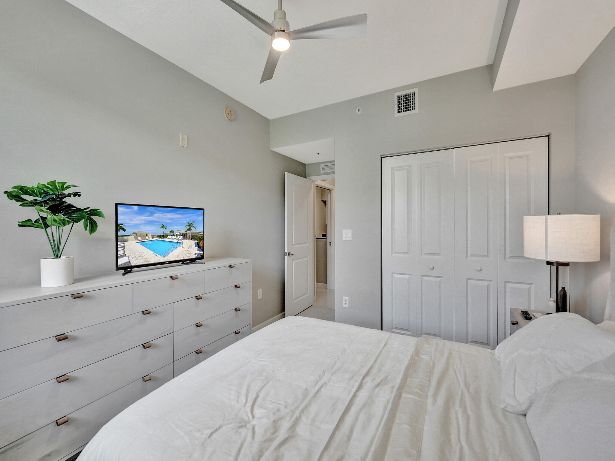 225 Northeast 1st Street, Unit 412 Delray Beach, FL 33444 - Photo 23 of 49 a bedroom with a bed and a painting on the wall