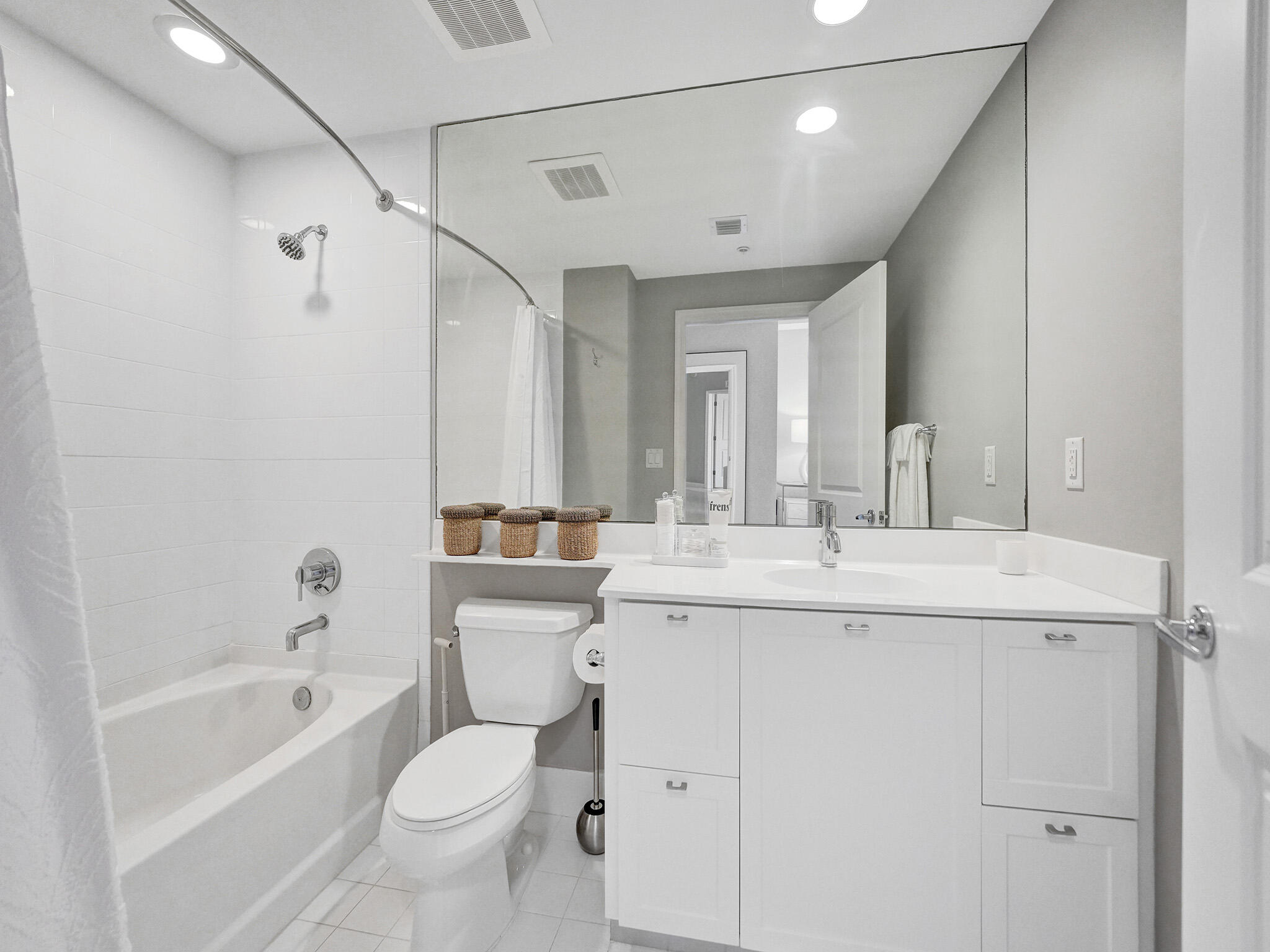 225 Northeast 1st Street, Unit 412 Delray Beach, FL 33444 - Photo 24 of 49 a bathroom with a granite countertop sink a toilet and shower