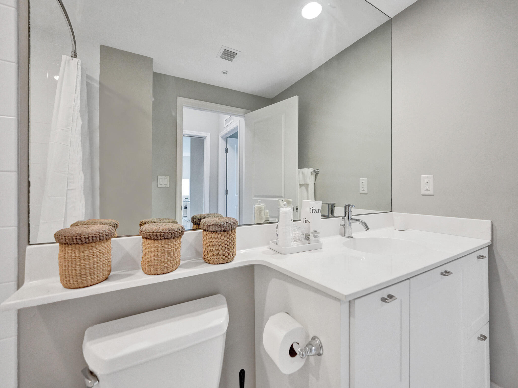225 Northeast 1st Street, Unit 412 Delray Beach, FL 33444 - Photo 25 of 49 a bathroom with a toilet sink and mirror