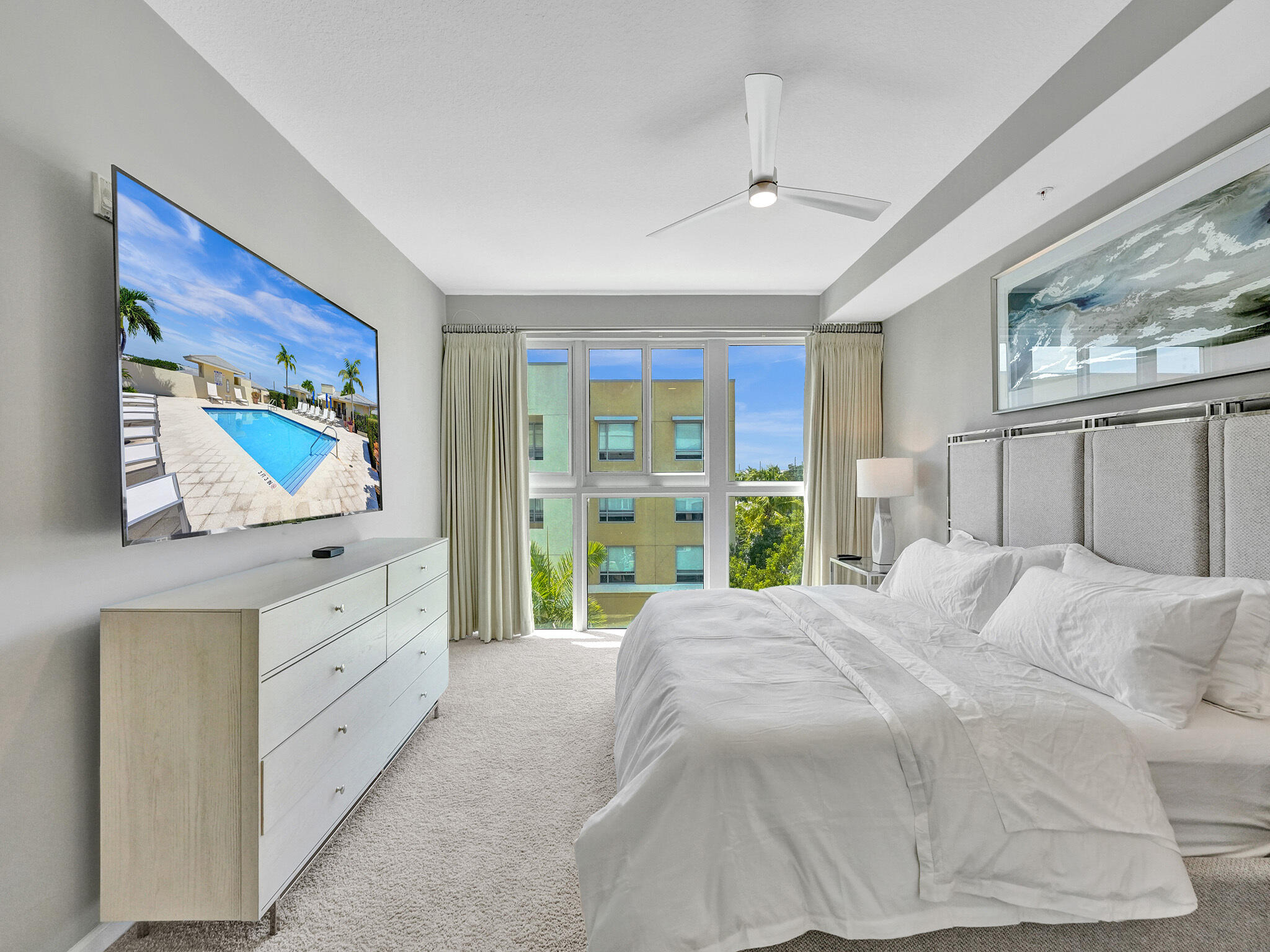 225 Northeast 1st Street, Unit 412 Delray Beach, FL 33444 - Photo 27 of 49 a bedroom with a bed and a flat screen tv