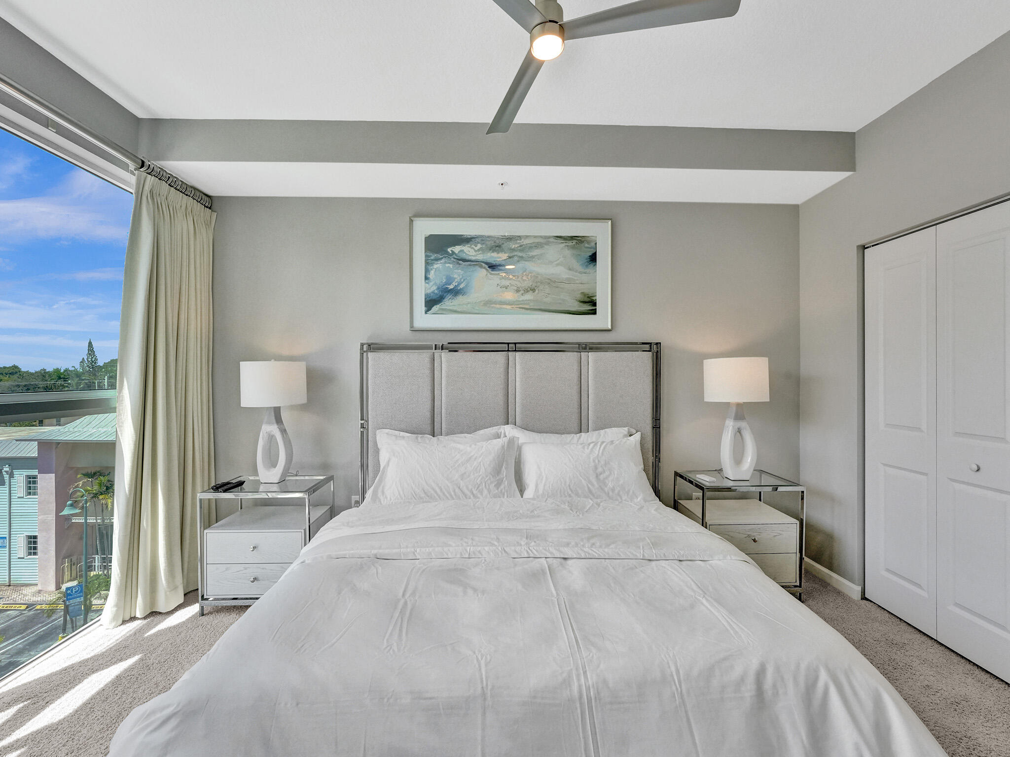 225 Northeast 1st Street, Unit 412 Delray Beach, FL 33444 - Photo 29 of 49 a bedroom with a bed and a painting on the wall