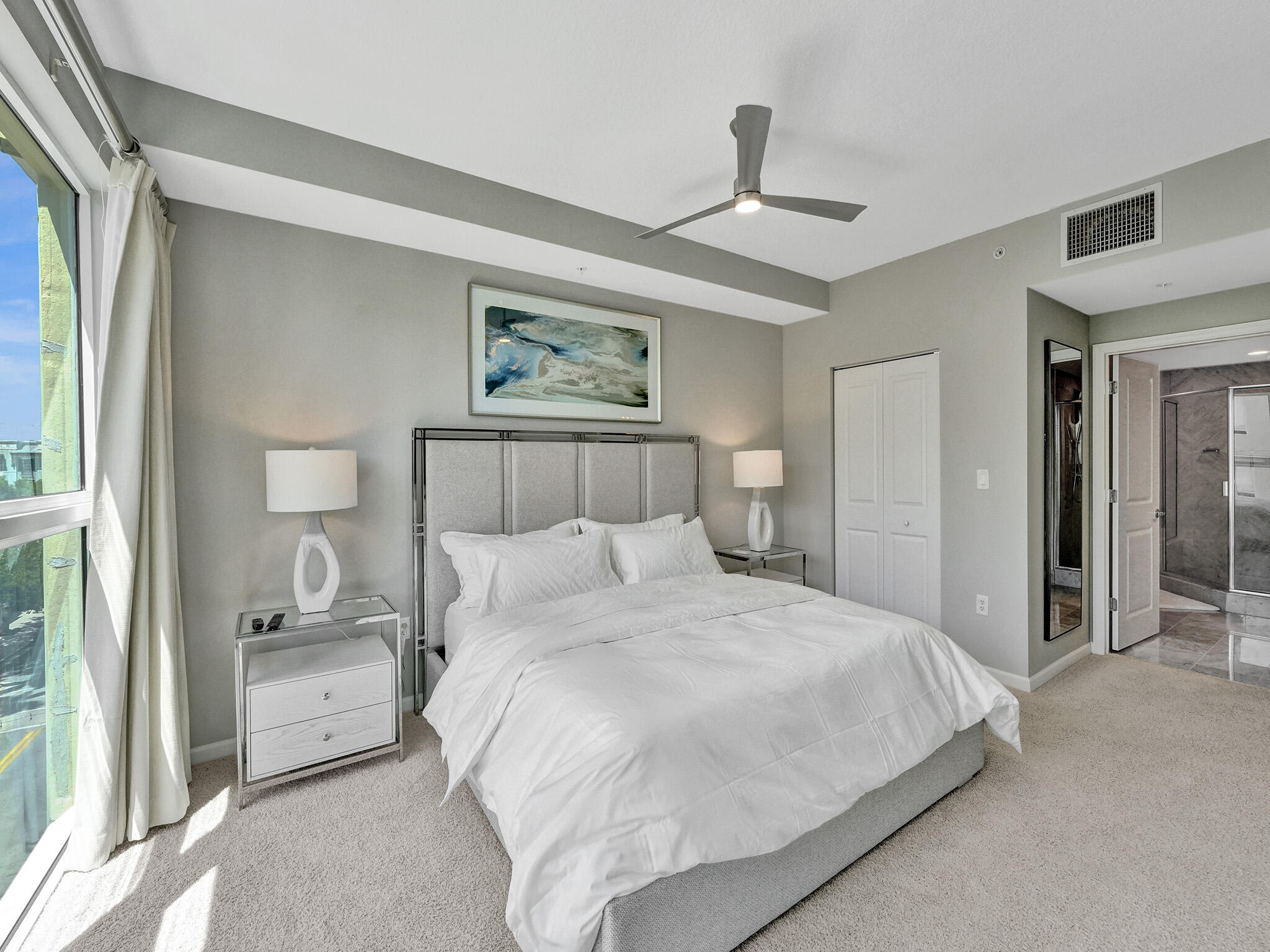 225 Northeast 1st Street, Unit 412 Delray Beach, FL 33444 - Photo 31 of 49 a bedroom with a bed and a painting on the wall