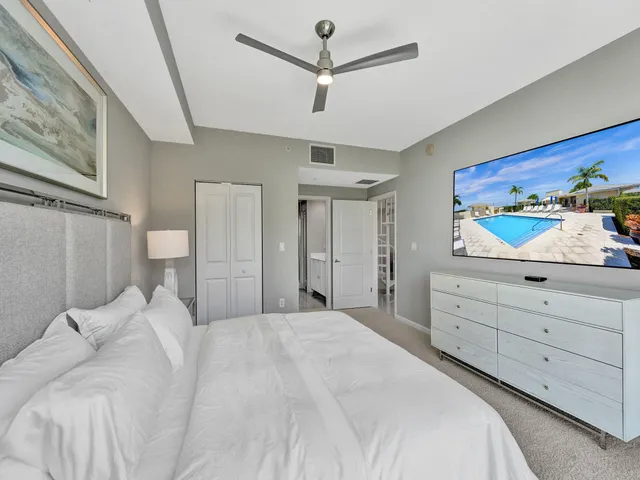 a bedroom with a bed and a painting on the wall