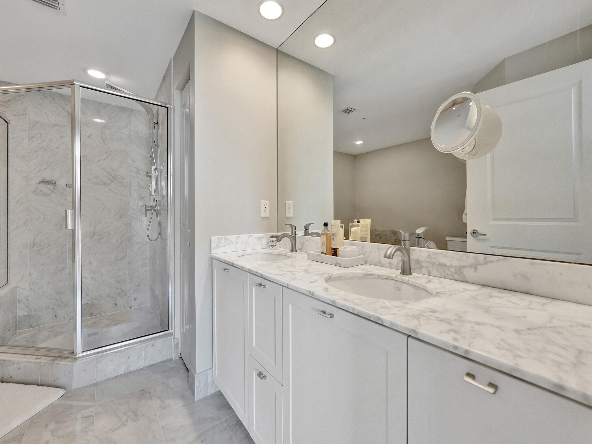 225 Northeast 1st Street, Unit 412 Delray Beach, FL 33444 - Photo 34 of 49 a bathroom with a shower sink and mirror