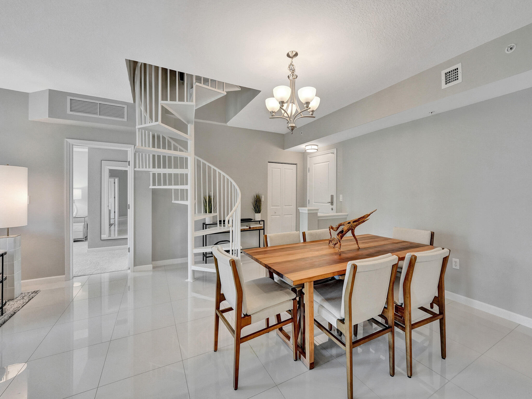 225 Northeast 1st Street, Unit 412 Delray Beach, FL 33444 - Photo 3 of 49 a view of a dining room with furniture and chandelier