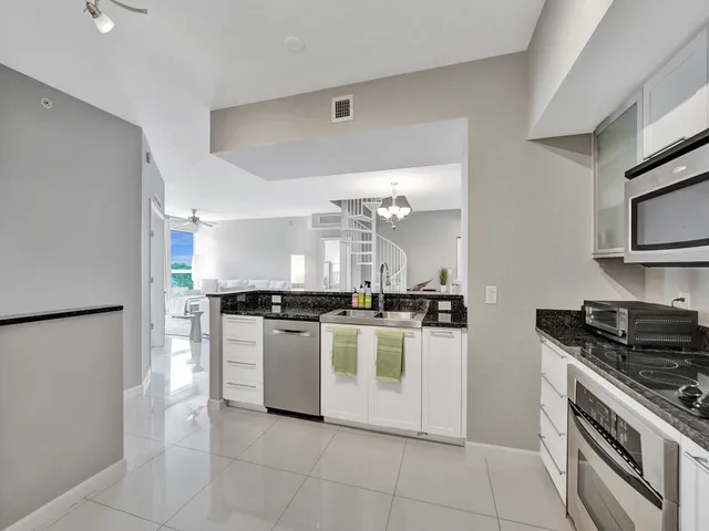 a kitchen with stainless steel appliances granite countertop a stove and a sink