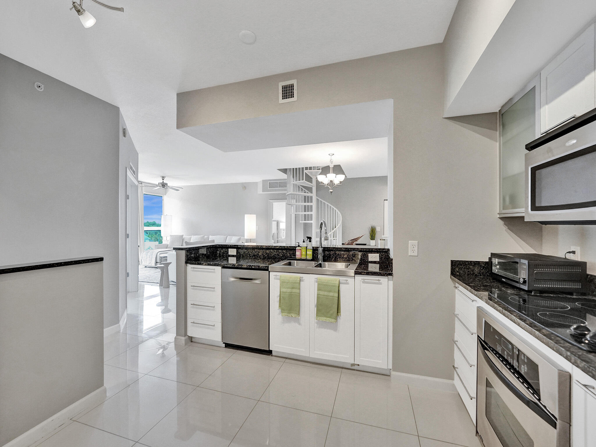 225 Northeast 1st Street, Unit 412 Delray Beach, FL 33444 - Photo 8 of 49 a kitchen with a stove top oven and cabinets