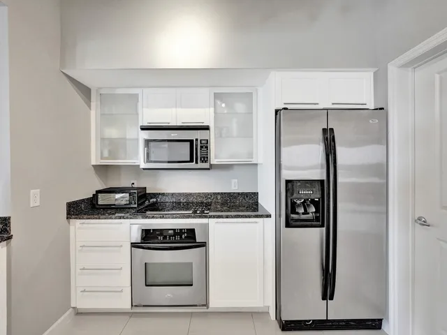 a kitchen with a stove top oven and cabinets