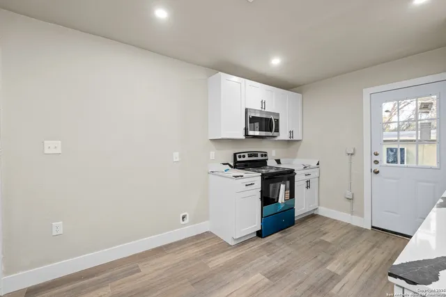 a kitchen with stainless steel appliances a stove a sink and a microwave