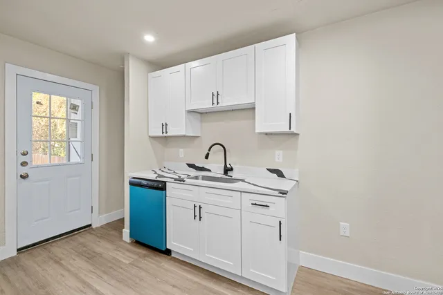 a view of cabinets a sink and dishwasher in a kitchen