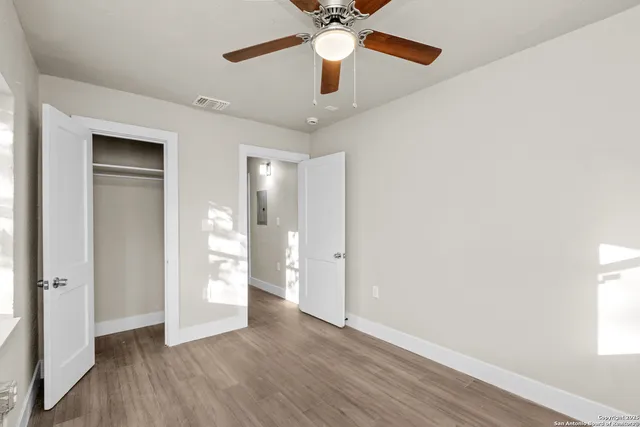 wooden floor in an empty room with a window