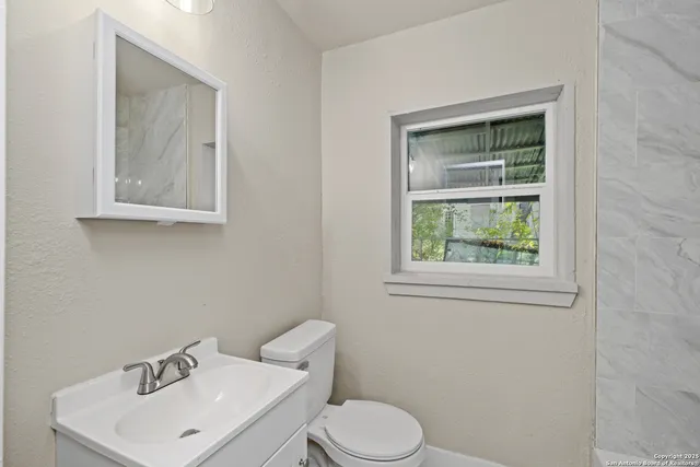 a white toilet sitting next to a bathroom sink