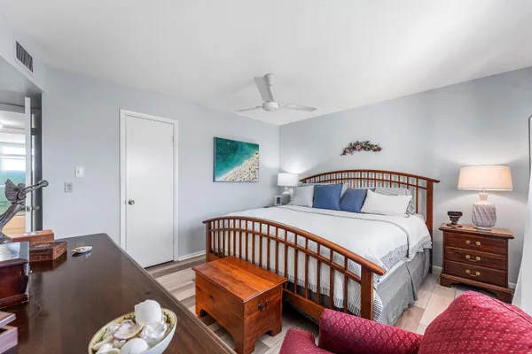 a bedroom with a bed a couch and dresser