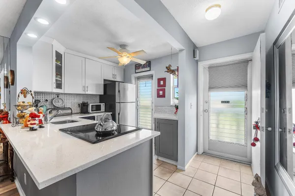 a kitchen with stainless steel appliances a refrigerator sink and cabinets