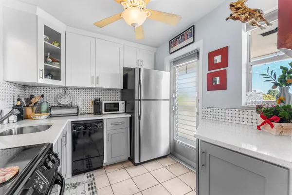 a kitchen with stainless steel appliances a sink cabinets and a refrigerator
