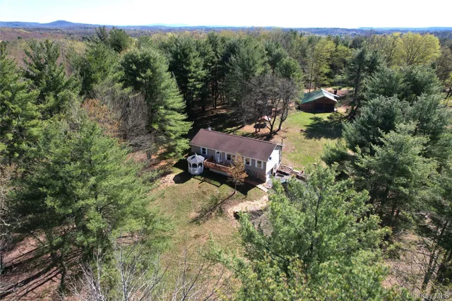 an aerial view of a house with a yard