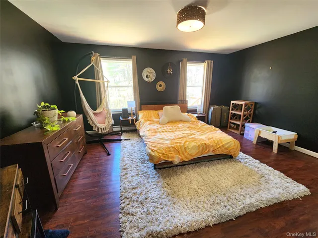 a bedroom with a bed window and a couch