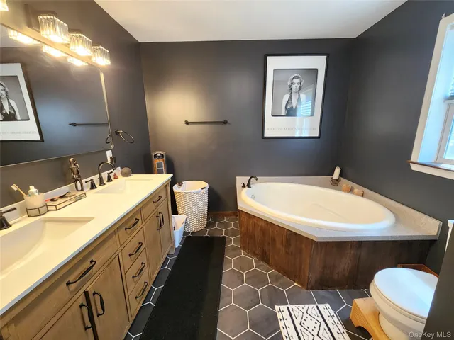 a spacious bathroom with a double vanity sink and a mirror