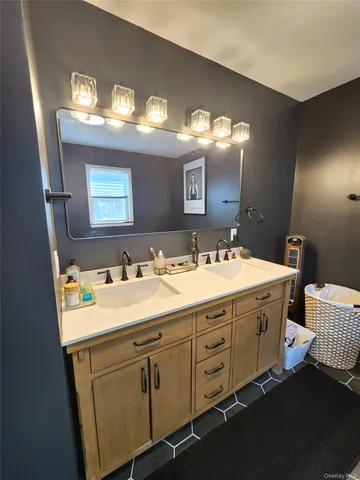 a bathroom with a sink vanity and mirror