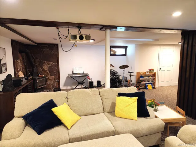 a living room with furniture and a large mirror