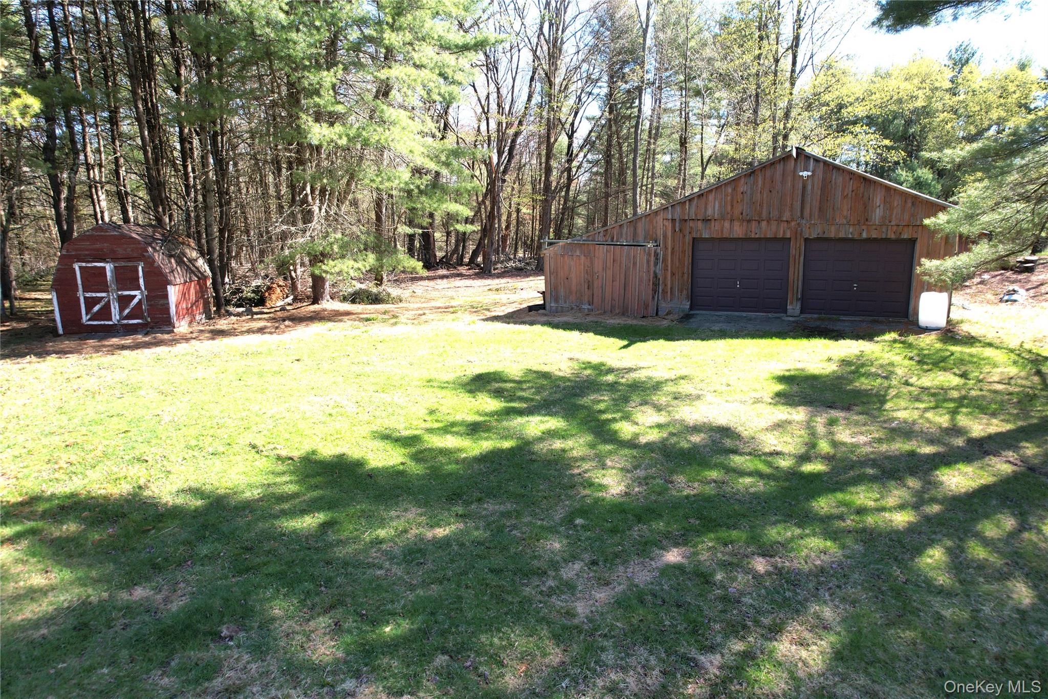 142 Old Tacy Road Bethel, NY 12783 - Photo 5 of 38 a front view of a house with a yard and covered with trees