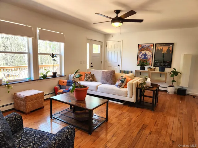a living room with furniture and wooden floor