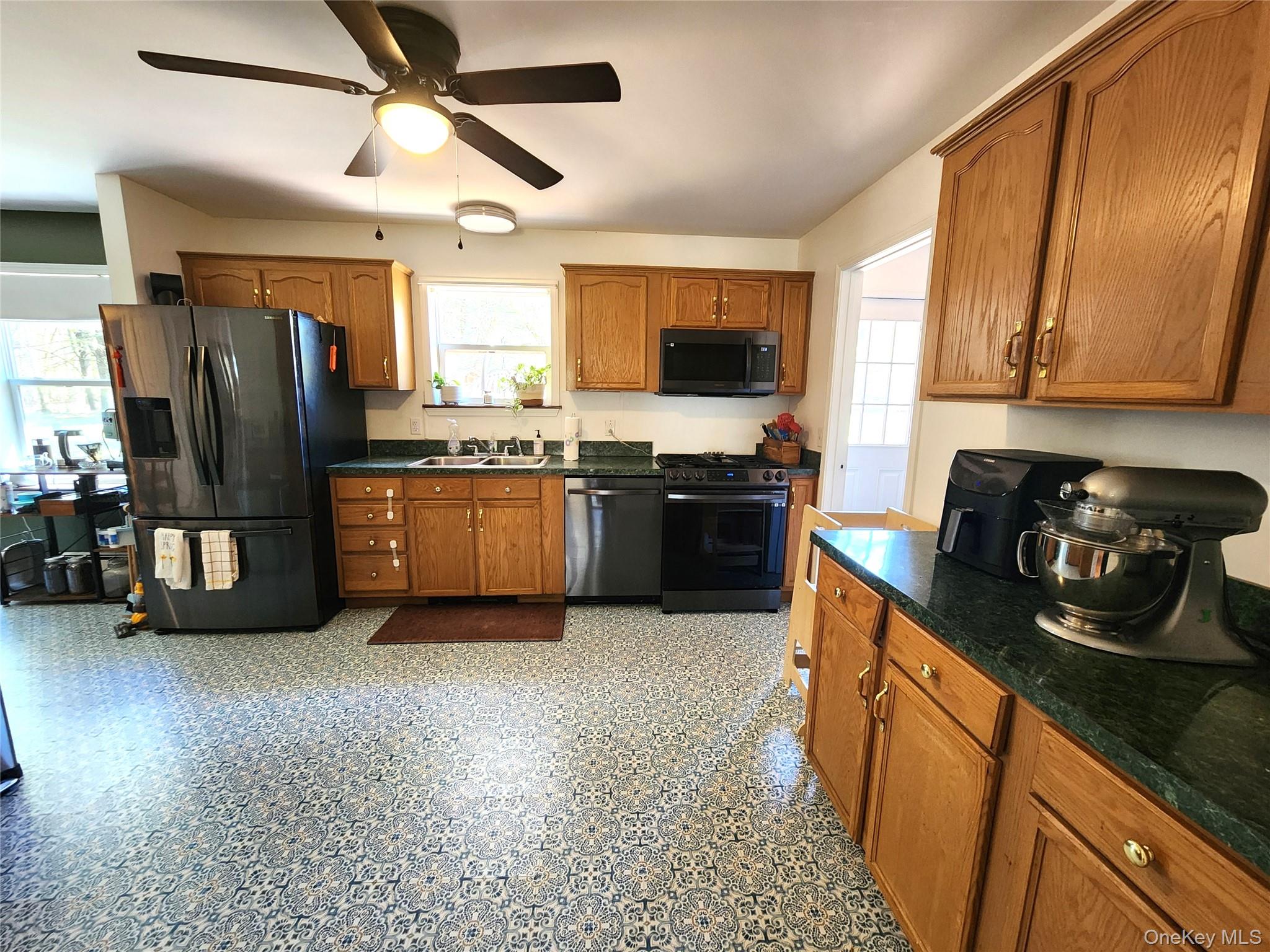 142 Old Tacy Road Bethel, NY 12783 - Photo 9 of 38 a kitchen with stainless steel appliances granite countertop a refrigerator a stove top oven a sink and dishwasher