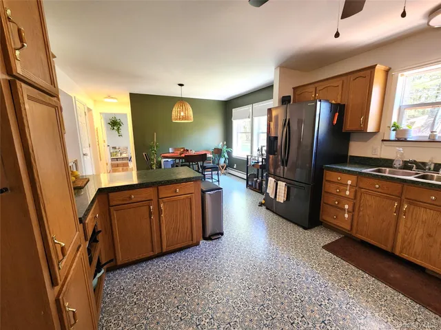 a kitchen with stainless steel appliances granite countertop a refrigerator stove and sink