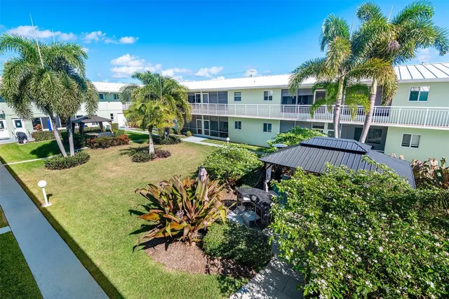 a view of a house with a yard patio and swimming pool