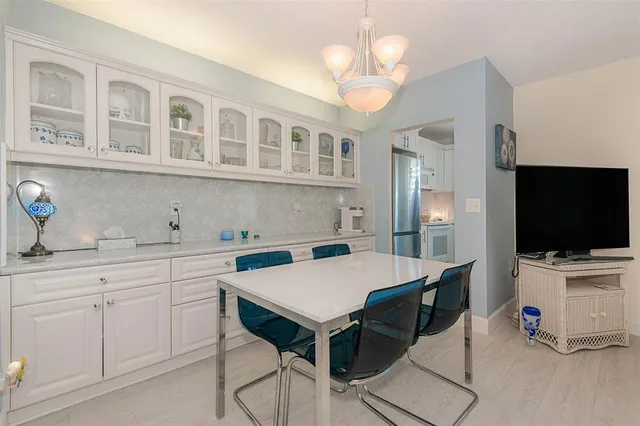 a view of a dining room with furniture and a flat screen tv