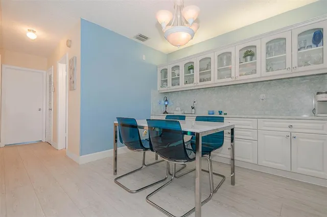 a view of a dining room with furniture and chandelier
