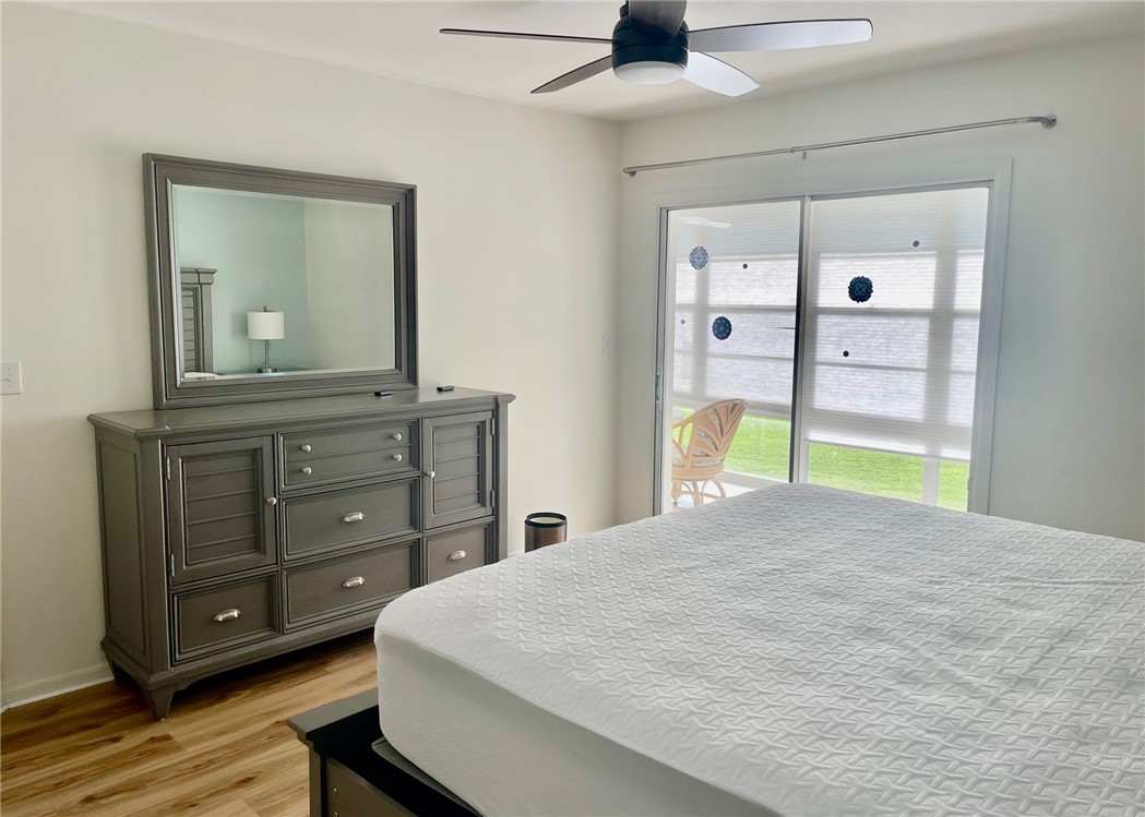 35 Pine Arbor Lane, Unit 202 Vero Beach, FL 32962 - Photo 9 of 16 a bedroom with a bed and a dresser