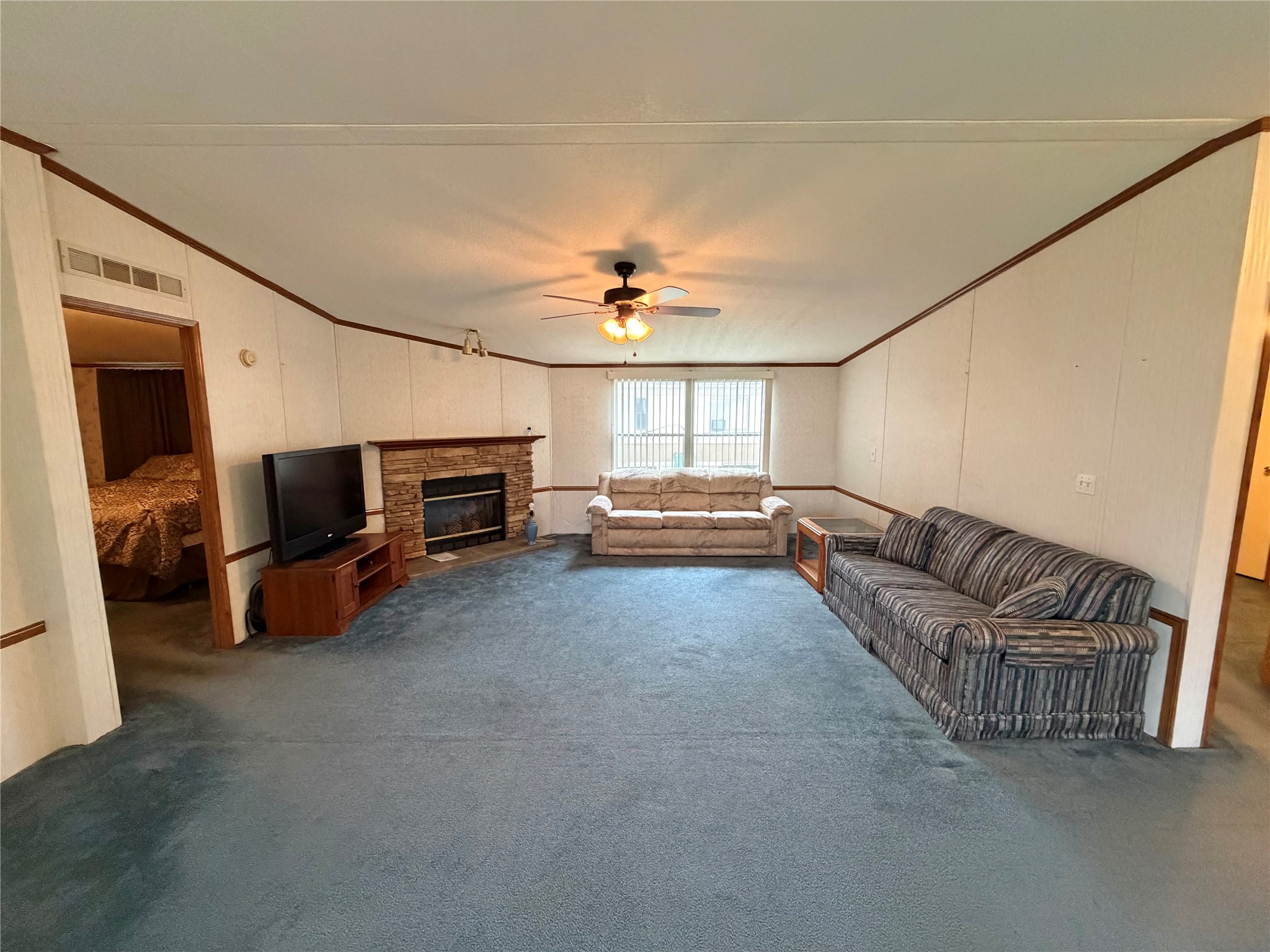 153 Prairie Lea Drive Angleton, TX 77515 - Photo 9 of 30 a living room with furniture and a flat screen tv