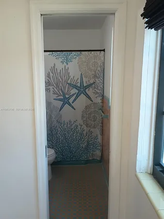 a bathroom with a shower curtain and a white sink