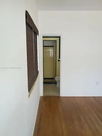 a bathroom with a granite countertop toilet and a shower