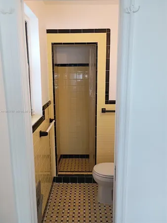 a bathroom with a shower and a mirror