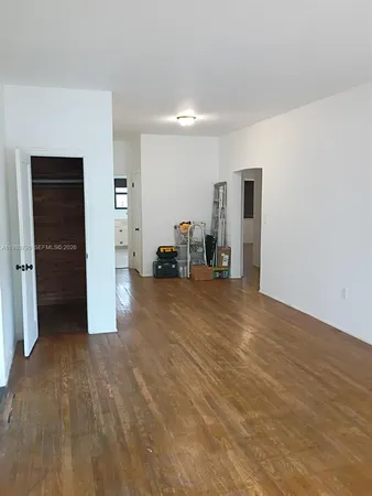 a view of a livingroom with furniture and a refrigerator