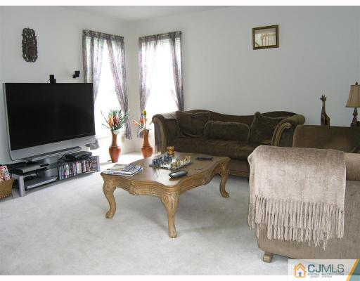 40 Timber Ridge Road North Brunswick, NJ 08902 - Photo 3 of 8 a living room with furniture and a flat screen tv