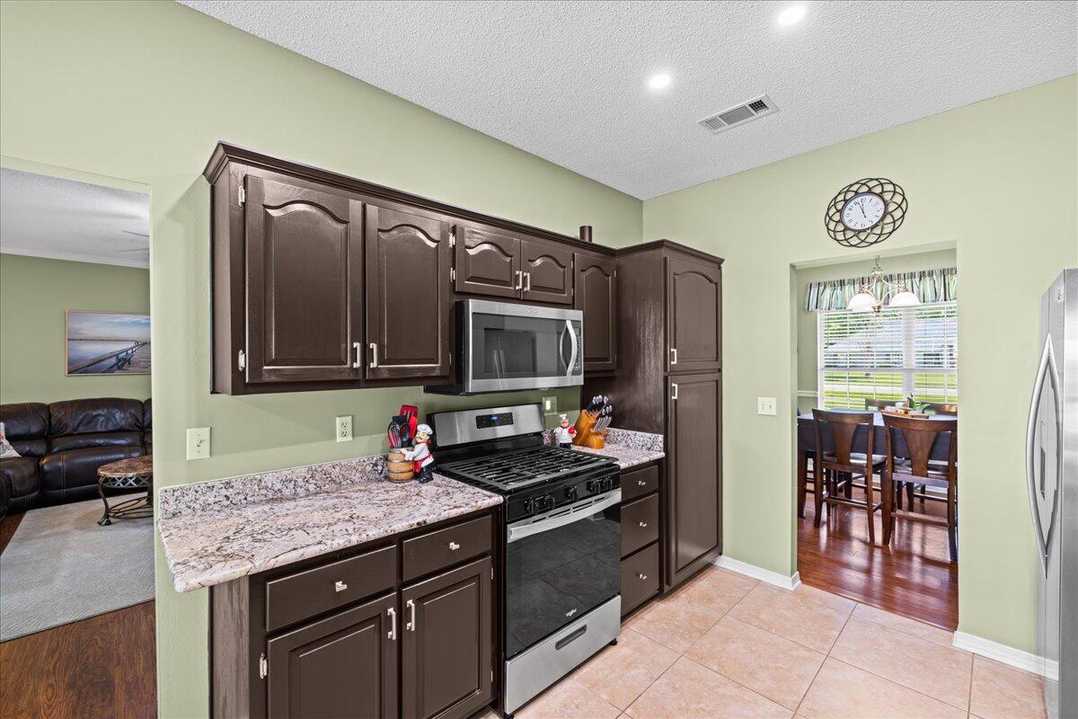 306 Tala Way Niceville, FL 32578 - Photo 11 of 47 a kitchen with stainless steel appliances granite countertop a sink and cabinets