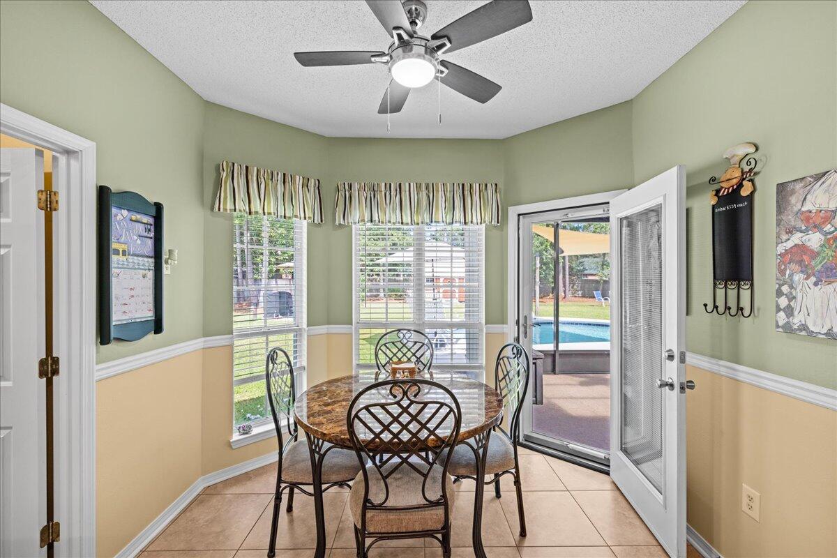 306 Tala Way Niceville, FL 32578 - Photo 12 of 47 a view of a dining room with furniture window and wooden floor