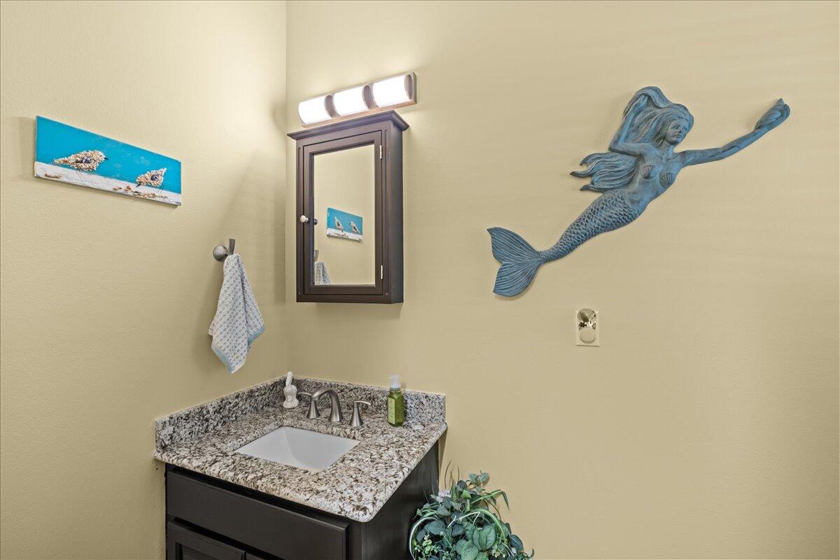 306 Tala Way Niceville, FL 32578 - Photo 14 of 47 a bathroom with a granite countertop sink and a mirror