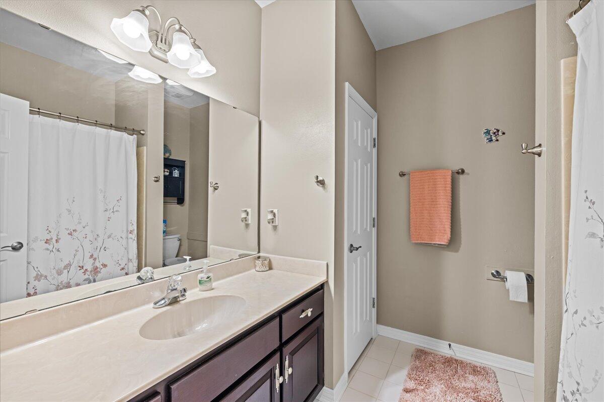 306 Tala Way Niceville, FL 32578 - Photo 19 of 47 a bathroom with a sink vanity granite shower and a mirror