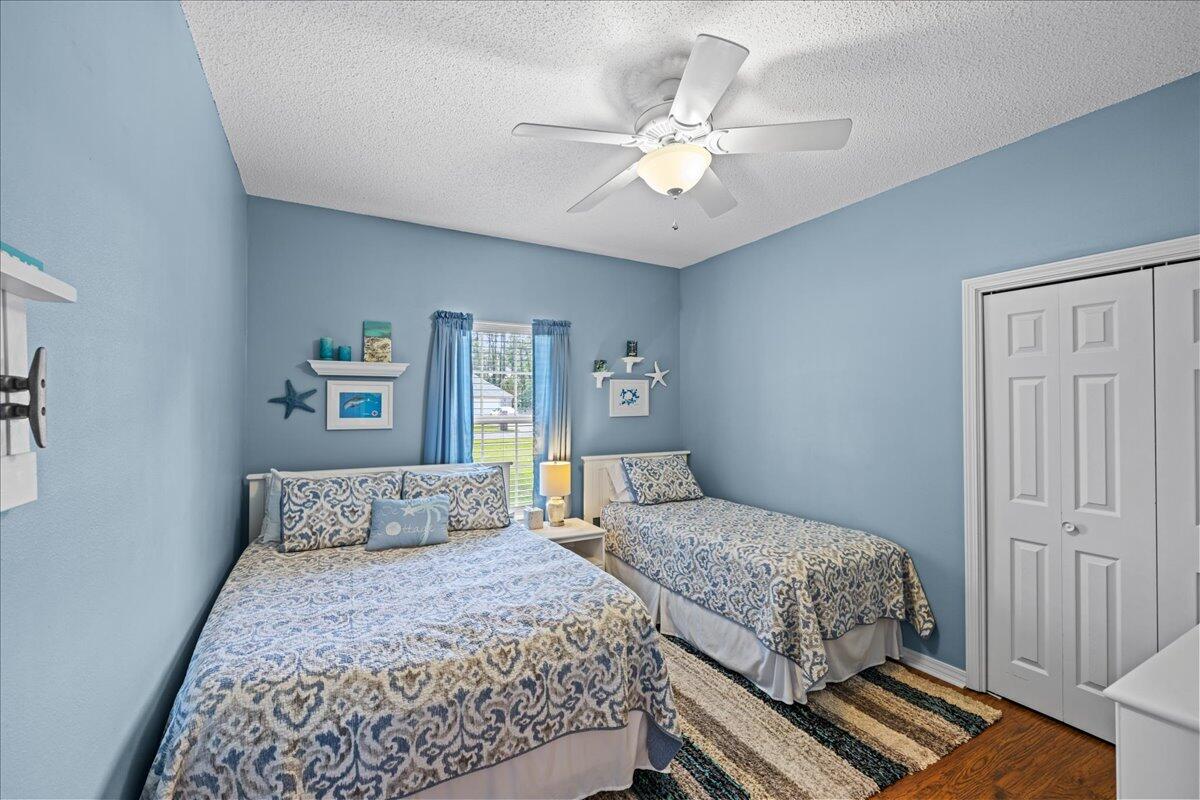 306 Tala Way Niceville, FL 32578 - Photo 20 of 47 a bedroom with a large bed and a chandelier